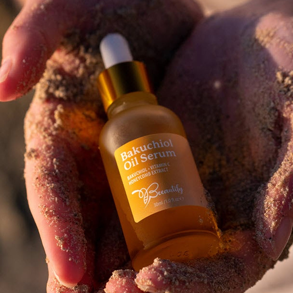 Bakuchiol Oil Serum bottle held between two hands with a natural background
